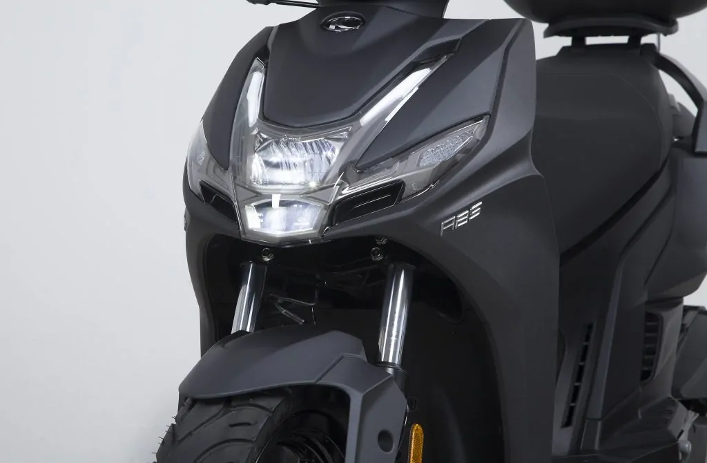 Front view and headlight of a modern Kymco motorbike for rental in Aegina
