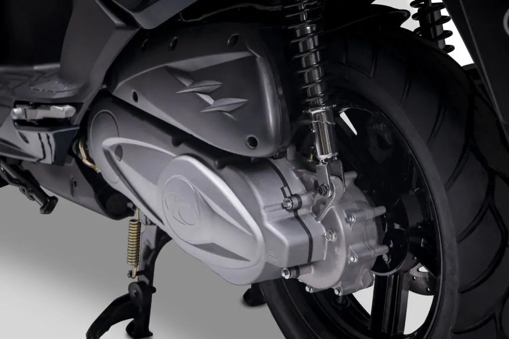 Rear engine and transmission detail of a Kymco scooter for rental in Aegina