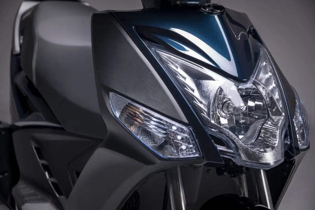 Front headlight and modern design of a Kymco Agility 125i 16+ scooter in Aegina