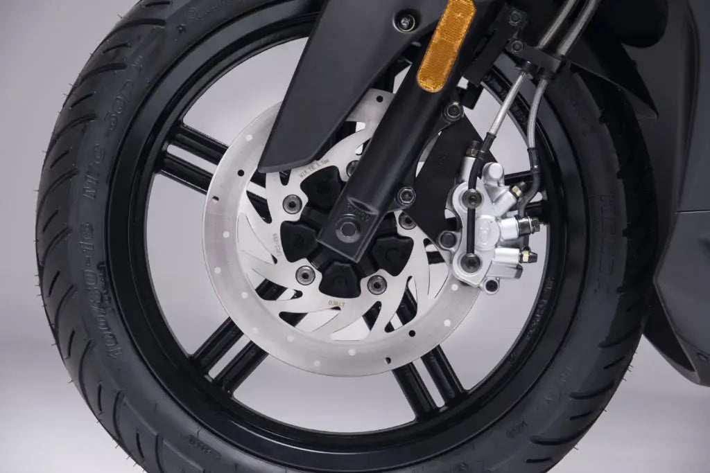 Front wheel and disc brake of a Kymco Agility 125i R16 scooter in Aegina